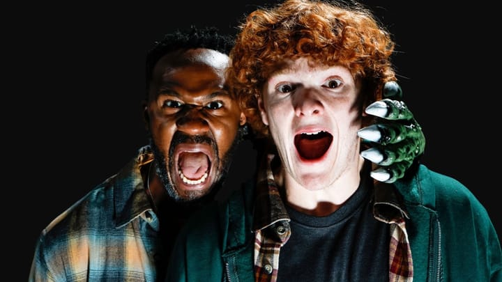 Two actors scream toward the camera, one with a green monster claw on his shoulder, against a black background.